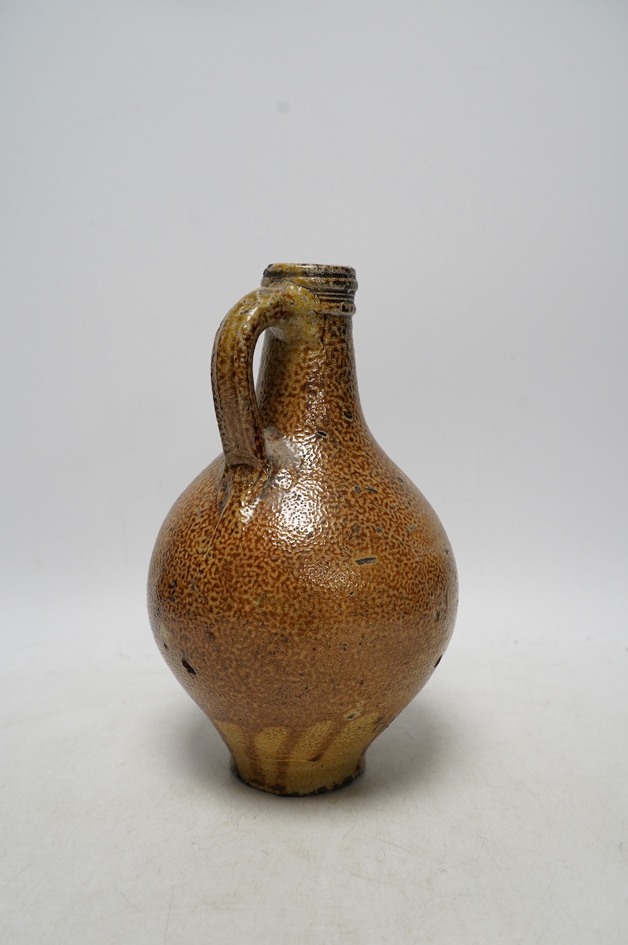 A 17th century Rhenish saltglazed Bellarmine, 23cm. Condition - commensurate with age